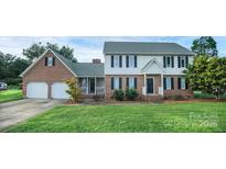 Charming brick and siding home with a well-manicured lawn and two-car garage at 106 Cameron Dr, Kings Mountain, NC 28086