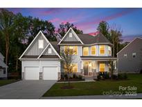 Beautiful two-story home featuring a manicured lawn and two-car garage at 6034 Jepson Ct, Charlotte, NC 28214