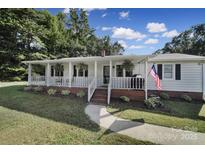 Ranch home with front porch, brick accents, and a large yard at 1020 Saint Paul Church Rd, Clover, SC 29710