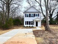 Two-story white house with black shutters and a concrete driveway at 127 Sharon Rd, York, SC 29745