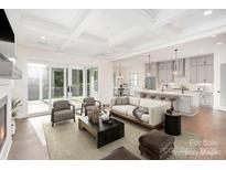 Bright and airy living room featuring an open-concept design with a modern kitchen and access to the outdoors at 1228 Sage Pine Cir, Clover, SC 29710