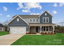 Two-story home with gray siding, white trim, and a two-car garage at 117 Brooke Forest Ct # 4, Mooresville, NC 28115