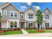 Three-unit townhome building, gray siding, green doors, landscaping at 10511 Boudreaux St, Huntersville, NC 28078