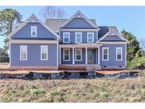 Two-story house with blue siding, white trim, and a covered porch at 332 Canvasback Rd, Mooresville, NC 28117