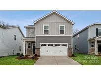 Two-story home with gray siding, white garage door, and landscaping at 335 Bezelle Ave, York, SC 29745