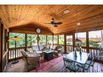 Relaxing screened porch with seating area and dining table, perfect for outdoor entertaining at 2594 Knoll Ridge Ct, Hickory, NC 28602