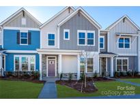 Modern townhome with blue and gray siding, and a purple front door at 10509 Boudreaux St, Huntersville, NC 28078