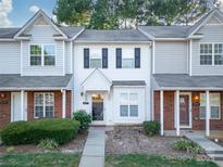 Charming townhome featuring neutral siding and a welcoming front entrance and front yard landscaping at 6427 Saint Bernard Way, Charlotte, NC 28269