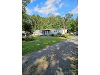 Ranch-style home with a spacious yard and mature trees at 735 Ned Marsh Rd, Salisbury, NC 28146