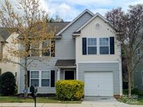 Charming two-story home featuring gray siding, black shutters, well-maintained lawn, and a one-car garage at 1327 Phil Oneil Dr, Charlotte, NC 28215