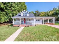 Charming single Gathering home featuring a inviting front porch and a well-maintained lawn at 60 Hunter Bridge Rd, Stony Point, NC 28678