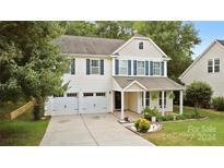 Two-story house with beige siding, white trim, and a double-car garage at 7223 Meyer Rd, Fort Mill, SC 29715