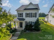 Charming two-story home with a well-manicured front yard and inviting front porch at 2531 Double Oaks Rd, Charlotte, NC 28206