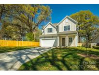 Charming two-story home featuring a well-maintained lawn, concrete driveway, and an attached two-car garage at 2630 Rose St, Charlotte, NC 28208