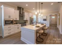 Modern kitchen features white cabinets, quartz countertops, and stainless steel appliances at 2630 Rose St, Charlotte, NC 28208