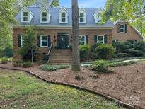 Charming brick home with dormer windows and a welcoming entrance and landscaped yard at 8503 Foxbridge Dr # 16, Matthews, NC 28104