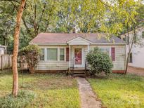 Ranch style home with red roof and mature landscaping at 2117 Laburnum Ave, Charlotte, NC 28205