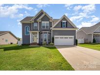 Charming two-story home featuring a well-manicured lawn and an attached two-car garage at 236 Pinnacle Xing, Shelby, NC 28152