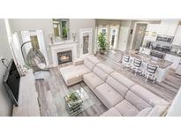 Airy living room features a fireplace, modern furniture, and view into the kitchen at 236 Pinnacle Xing, Shelby, NC 28152