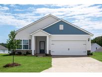 Inviting single-Gathering home featuring a two-car garage, beautiful lawn, stone accents and a covered front porch at 3607 Clover Valley Dr, Gastonia, NC 28052