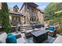 Relaxing patio with fire pit and seating area, perfect for outdoor entertaining at 5942 Carmel Rd, Charlotte, NC 28226