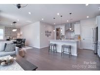 Open concept kitchen boasts stainless steel appliances and an island with seating at 5911 Mantle Way, Kannapolis, NC 28081