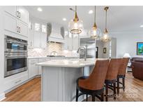 Modern kitchen with white cabinets, quartz countertops, and stainless steel appliances at 1353 Millview Ln, Matthews, NC 28104