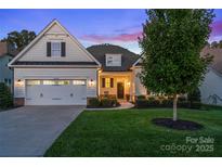 Charming home featuring a manicured lawn, well-lit facade, and attached two-car garage at 4028 Brandywine Ter, Lancaster, SC 29720