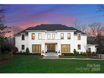 Stunning two-story home with white brick exterior and landscaped lawn at 3645 Pelham Ln, Charlotte, NC 28211