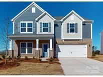 Two-story house with gray and beige siding, a two-car garage, and a front porch at 1805 Augustine St, Monroe, NC 28112