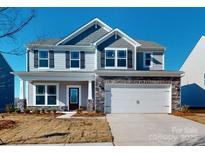 Two-story house with gray siding, stone accents, and a two-car garage at 1809 Augustine St, Monroe, NC 28112