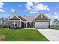 Charming single-story home with a well-manicured lawn and inviting two-car garage, creating instant curb appeal at 120 Brooke Forest Ct, Mooresville, NC 28115