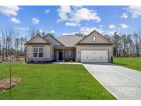 Charming single-story home with a well-manicured lawn and attached two-car garage at 132 Brooke Forest Ct, Mooresville, NC 28115