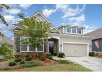 Attractive craftsman style home with a two-car garage and landscaped front yard at 5018 Grand Champion Ct, Iron Station, NC 28080