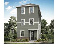 Three-story home with gray siding, multiple windows, and a brick base at 207 Davidson Gateway Dr, Davidson, NC 28036