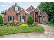 Charming brick home featuring manicured landscaping, arched windows, and a welcoming front entrance at 2840 Wheat Field Ct, Lincolnton, NC 28092