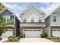 Charming townhome featuring stone accents, a two-car garage, and a well-maintained lawn at 7456 Hartsfield Dr, Lancaster, SC 29720