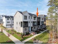 Modern townhome with neutral siding, brick accents, and a well-maintained lawn and landscape at 432 Nathaniel Way # Brx0043, Charlotte, NC 28213