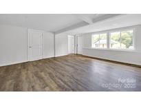 Bright living room with hardwood floors and neutral color palette at 123 Market Rd, Mooresville, NC 28115