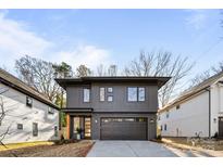 Modern two-story home with dark gray siding and attached garage at 3623 Avalon Ave, Charlotte, NC 28208