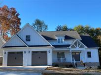 Two-story house with gray double garage doors and a front porch at 409 19Th Avenue Nw Cir # 12, Hickory, NC 28601