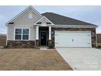 One-story home with stone and shingle accents, a two-car garage, and a well-manicured lawn at 225 Brinkley Rd # 99, Kings Mountain, NC 28086