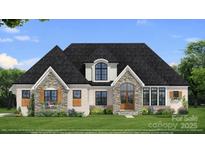 Charming home showcasing stone and white brick, complemented by manicured lawn and beautiful landscaping at 00 Mcfalls Ln # 02, Indian Land, SC 29707