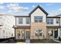 Charming new construction townhouse with brick and siding exterior and manicured landscaping at 3112 Beacon Heights Rd, Indian Land, SC 29707