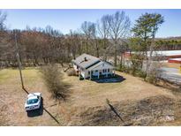 Charming single Gathering home featuring a covered front porch and a classic white Corvette in the driveway at 1123 Hwy 70 Hwy, Newton, NC 28658