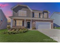 Two-story house with stone accents and a two-car garage at 141 Slip Shot Ln, Troutman, NC 28166