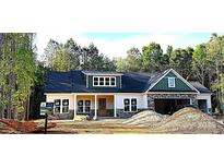 Charming single Gathering home with a mix of stone and vinyl siding and an attached two-car garage at 1025 Baylor Grv, Monroe, NC 28112
