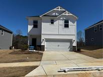 Charming two-story home featuring white siding, a two-car garage, and a well-manicured front yard at 203 Alden Ct, Shelby, NC 28152