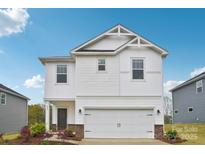 Charming two-story home with a white exterior, attached garage, and manicured lawn at 203 Alden Ct, Shelby, NC 28152