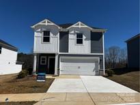 Charming two-story home featuring vertical siding, a two-car garage, and a well-manicured front lawn at 205 Alden Ct, Shelby, NC 28152